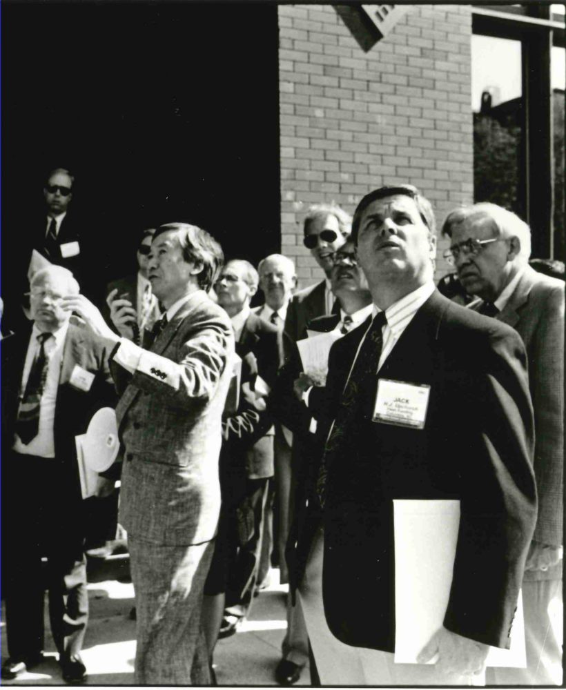 Photo- Weiming Lu stands at the center of a group of people, acting as host to an international delegation inspecting the dramatic transformations in Lowertown, St. Paul Weiming Lu papers, N279, Northwest Architectural Archives