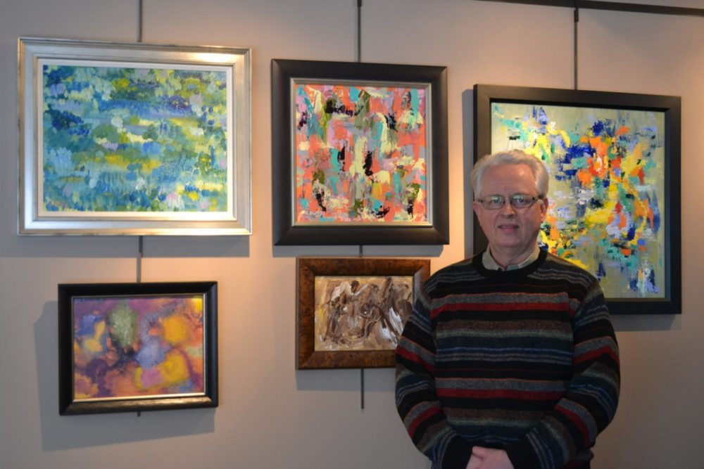 Artist Ron Duffy with paintings from the Brushed Back to Life series.