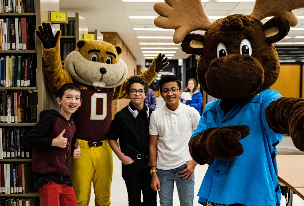 Goldy and Mooster pose with three Gopherbaloo students