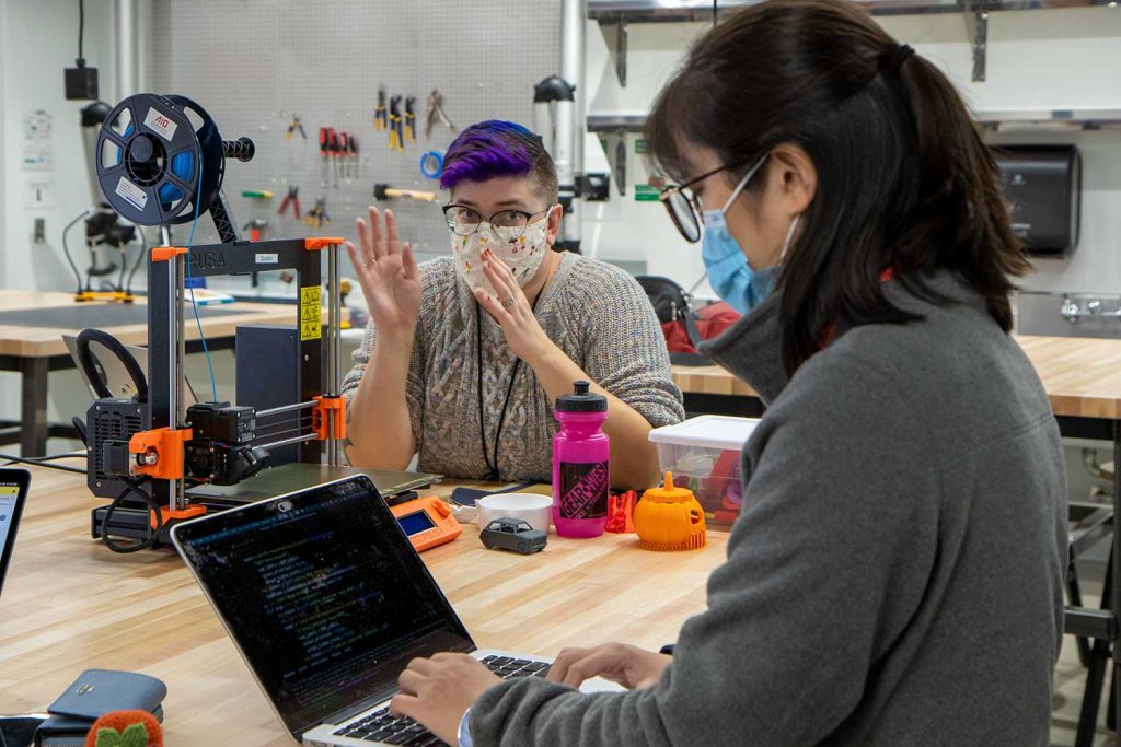 Librarian Carolyn Bishoff gives 3D printing tips to student Changye Li in the Health Sciences Library Makerspace.