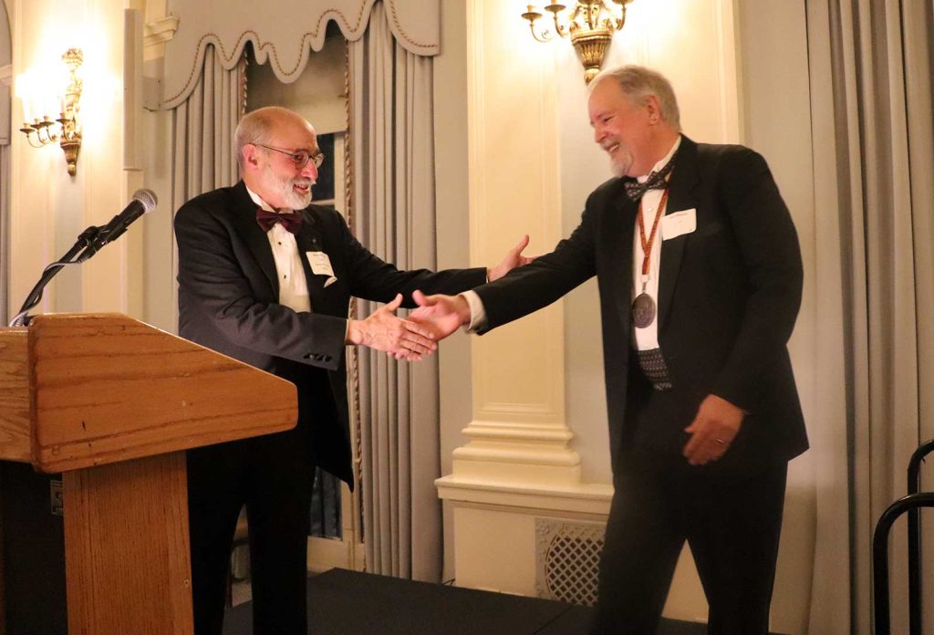 Tim Johnson, invited to become a member of the Baker Street Irregulars, received his investiture from Michael Kean. (Photo courtesy Ben Vizoskie and the Baker Street Irregulars.)