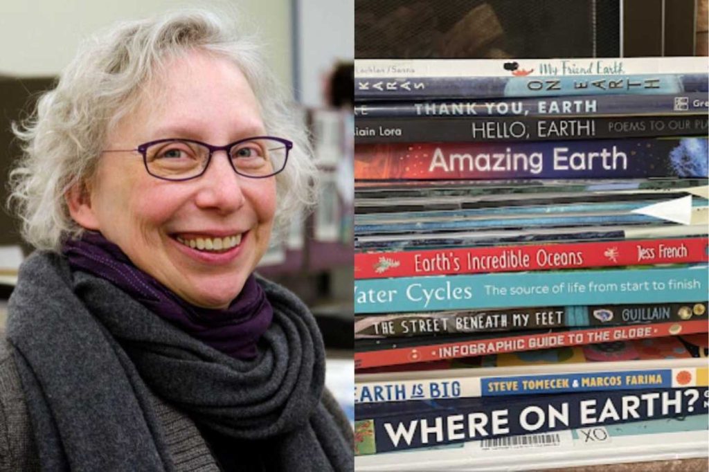 Lisa Von Drasek with a stack of children's books.