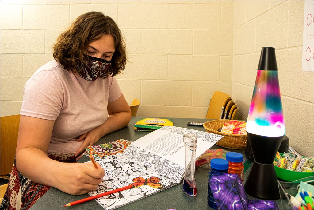 Student employee Grace tries out some of the stressbusters in the Sensory Room.