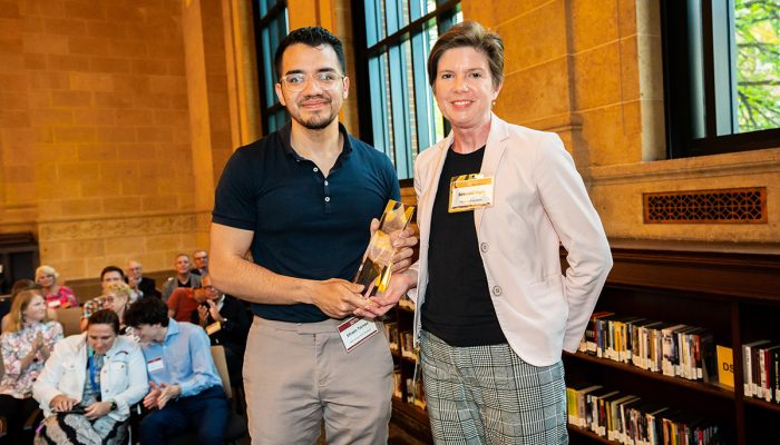 Founders Day 1 Student holding glass award next to professor at Founders Day 2023