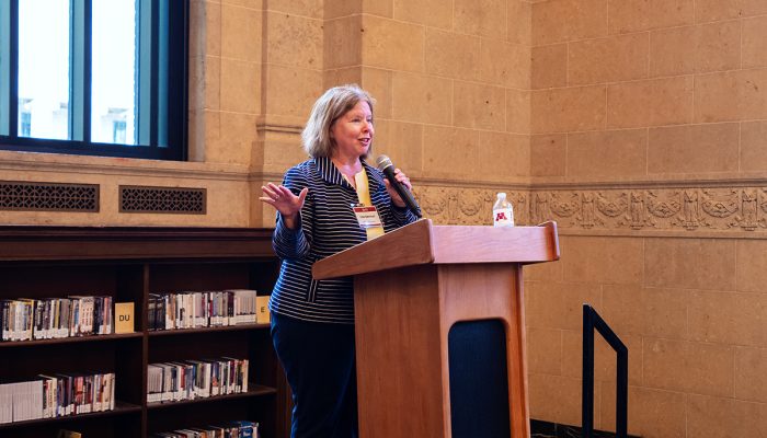 Founders Day 10 Dean Lisa German in front of a podium speaking at Founders Day