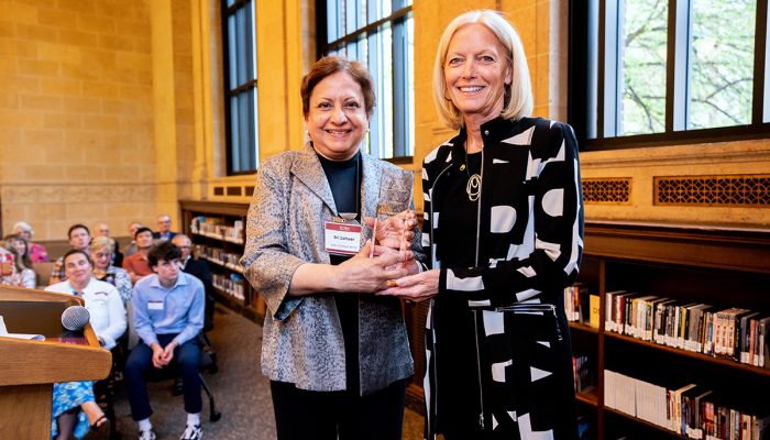Founders Day 2 Woman holding glass award next to Sri Zaheer, Carlson School of Management Dean, at Founders Day 2023