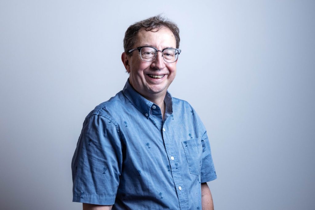 Erik Biever, the Integration, Identity, and Information Security Analyst for UMN Libraries, poses for a portrait on July 18, 2023, in Walter Library. Biever will retire after over 40 years at the Libraries. (Photo/Adria Carpenter)