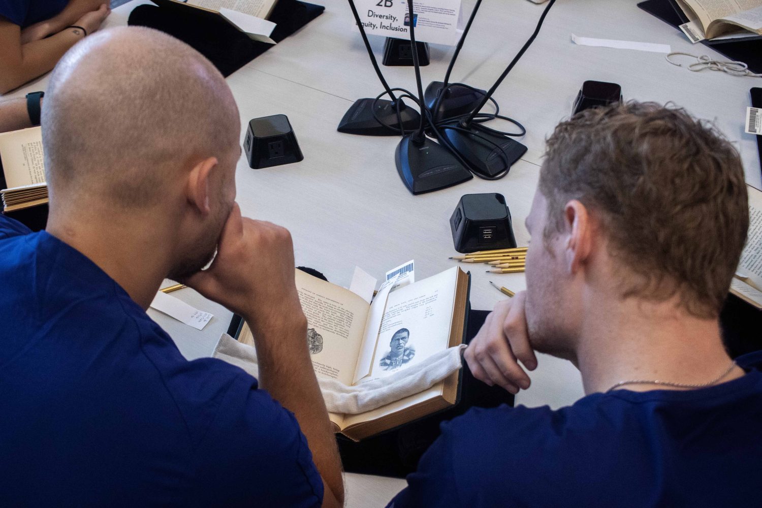 Two dental students read a book from The Wangensteen Historical Library of Biology and Medicine. (Photo/Adria Carpenter)