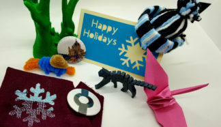 Examples of things you can make in the makerspaces: 3D printed figures, cards, buttons, embroidered cloth, origami cranes, yarn hats.