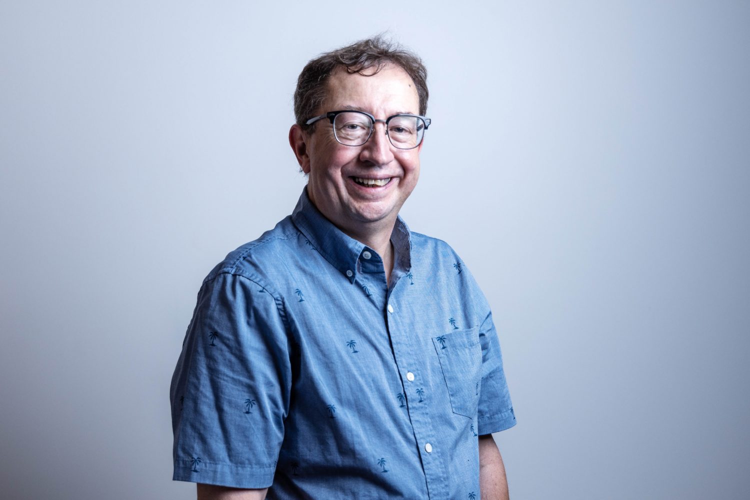 Erik Biever, the Integration, Identity, and Information Security Analyst for UMN Libraries, poses for a portrait on July 18, 2023, in Walter Library. Biever will retire after over 40 years at the Libraries. (Photo/Adria Carpenter)