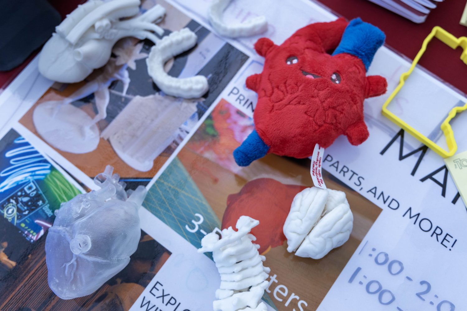 A happy heart and 3d-printed objects decorate the table for the Health Science Library's Makerspace. (Photo/Adria Carpenter)