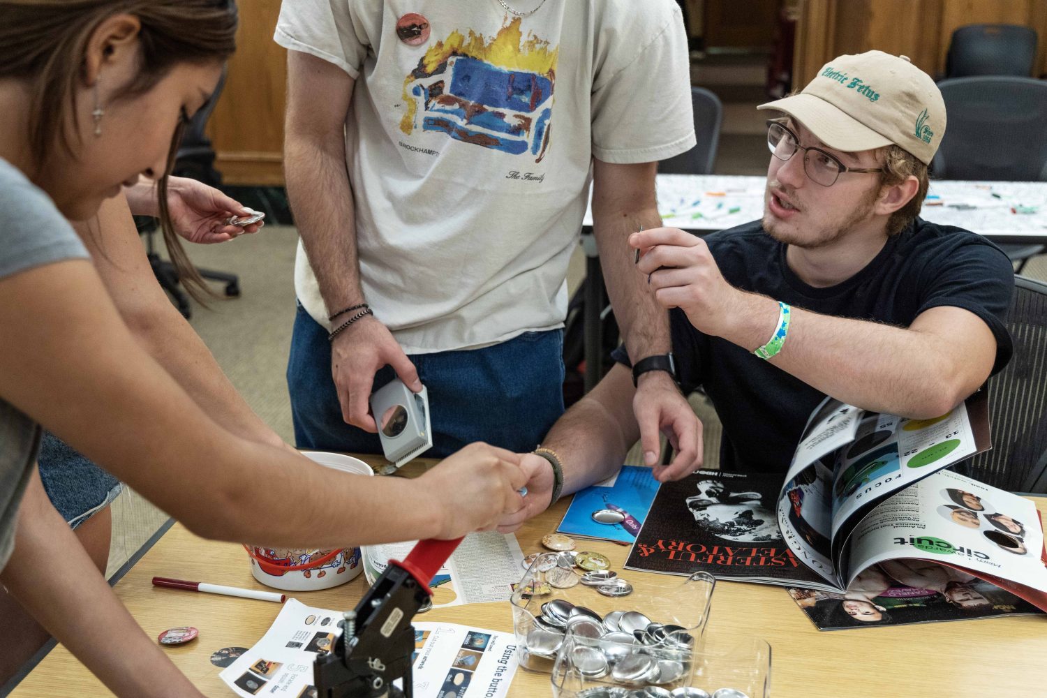 Students in the Chill Zone room make buttons with cutouts from magazines. (Photo/Adria Carpenter)