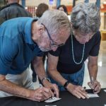 Guests gather, talk, and eat foot at the Symbolic Significance exhibit opening event on Monday, Sept. 11, 2023. (Photo/Adria Carpenter)