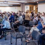 Guests gather, talk, and eat foot at the Symbolic Significance exhibit opening event on Monday, Sept. 11, 2023. (Photo/Adria Carpenter)
