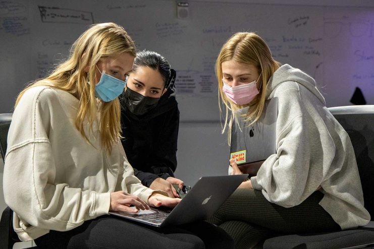 Three undergraduate design students working on their project in the Libraries VR Studio. 
