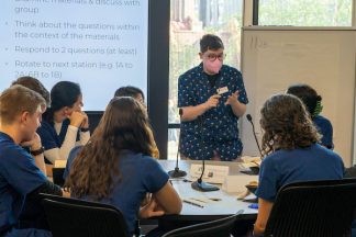 Ai Miller leads a discussion about DEIA within dentistry to a group of first year dental students