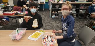 Annie Henly and student mending shoes.