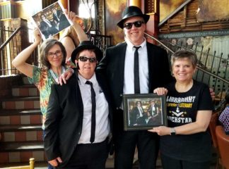 Claire Stewart, Betsy Friesen, Shane Nackerud, and Wendy Lougee with Betsy and Shane dressed as the Blues Brothers