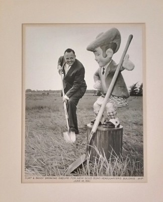 Photograph of Curt Carlson and Gold Bond Stamp Company Mascot, Sandy Saver, at groundbreaking ceremony for Minneapolis Industrial Park.