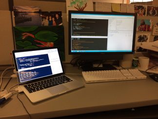 picture of a laptop next to a desktop computer