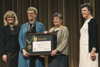 Wendy Lougee and Jennifer Gunn accept the National Medal for Museum and Library Service. At far left is Dr. Kathryn K. Matthew, director of the Institute of Museum and Library Services. At far right is Cokie Roberts, Journalist and Commentator for National Public Radio and ABC News.