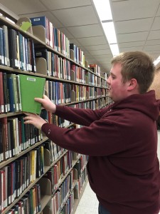  Alex is shelving recently returned books.