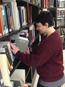Sara is preparing books to be put on the hold shelf, so you can pick them up.
