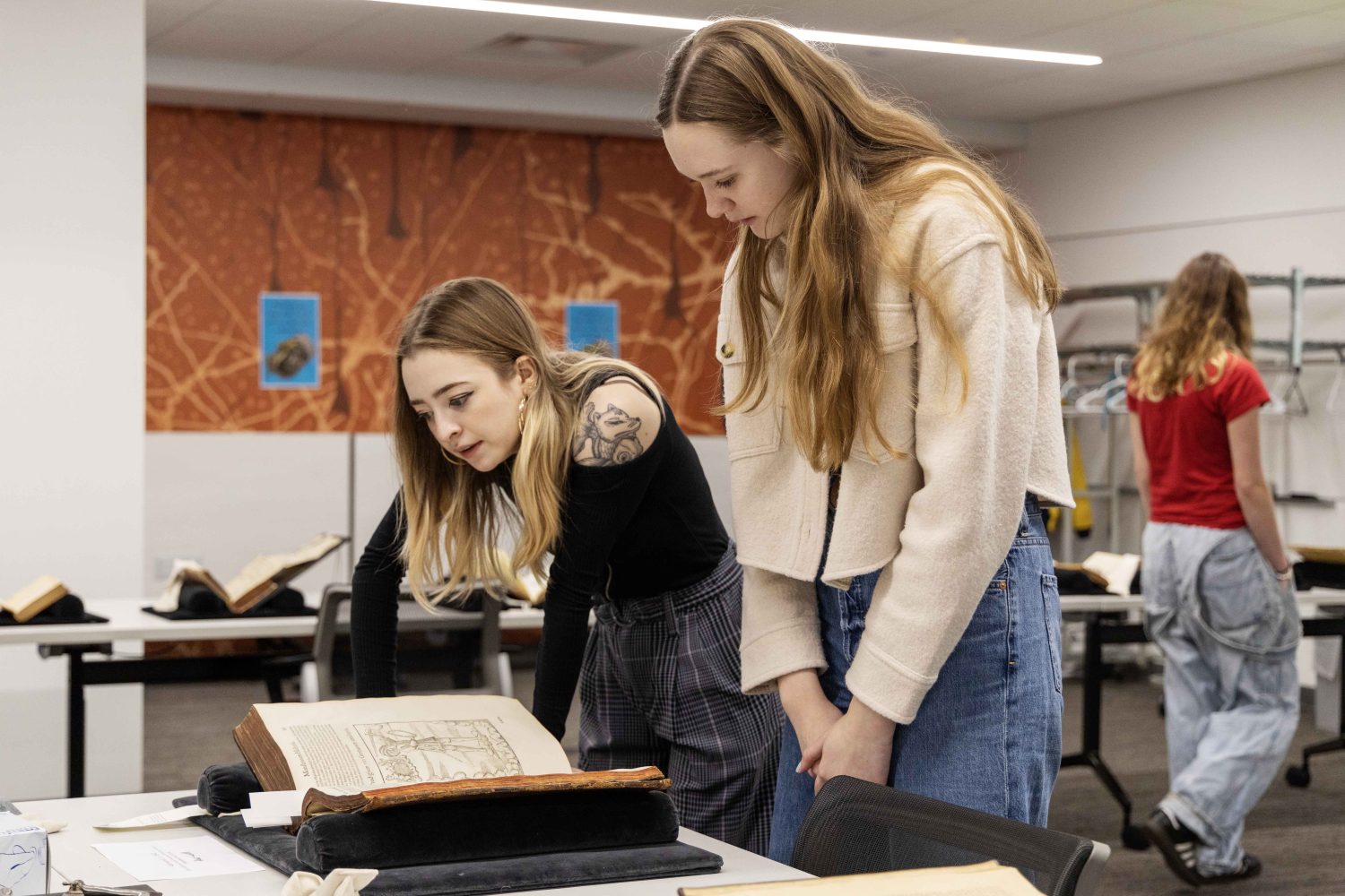Students read rare books at the Wangensteen pop-up exhibit.