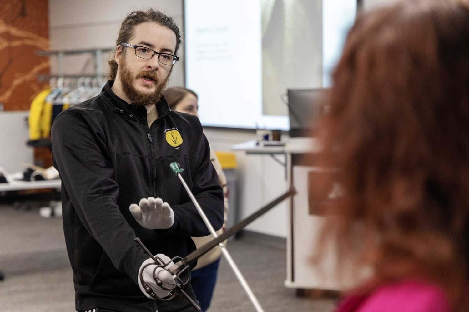 Dale Utt III of the Oakeshott Institute demonstrates how to duel during the Wangensteen pop-up exhibit.