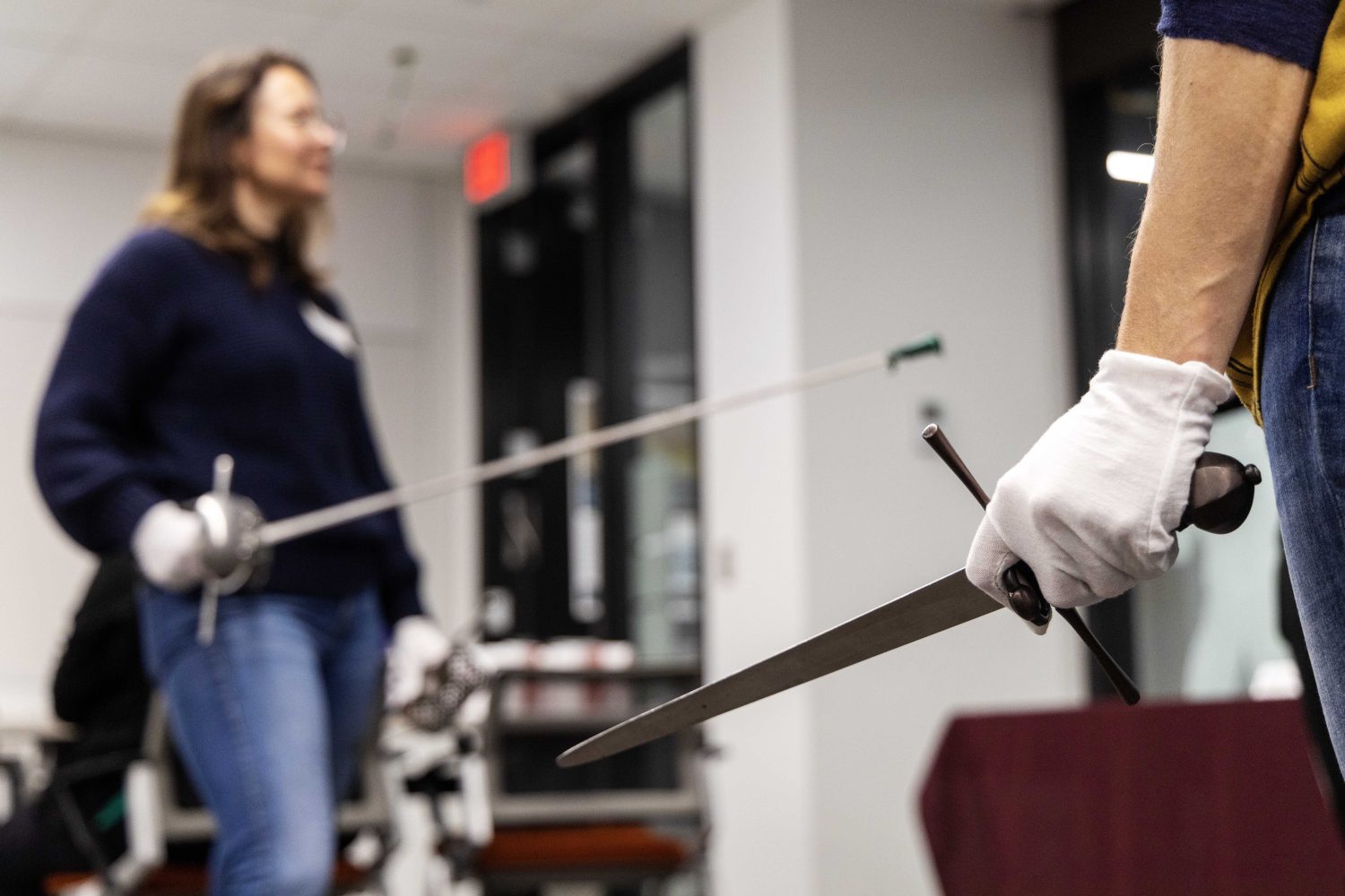 Attendees learn how to duel with swords at the Wangensteen pop-up exhibit.