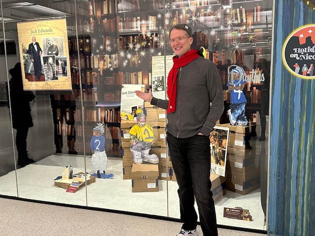 Darren Terpstra poses in front of the holiday display windows.