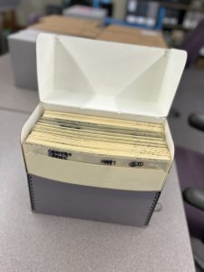 Box of processed prints placed inside a gray archival box.