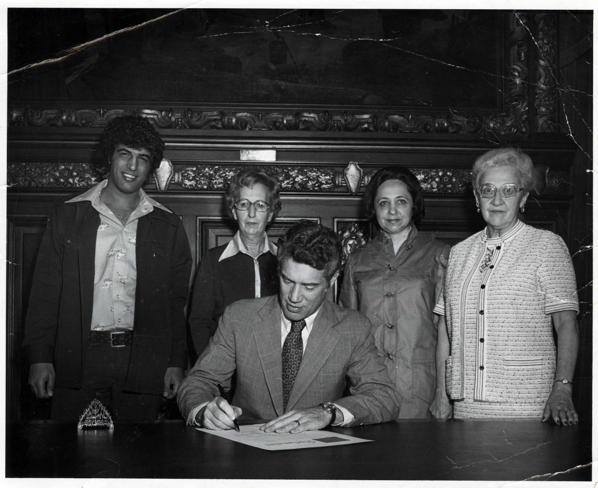 Governor Wendell Anderson signing Holocaust Day Proclamation in St. Paul, Minnesota. Included in the photograph: Ami Yemini, Ethel Levey, Felicia Weingarten, and Adeline Fremland.