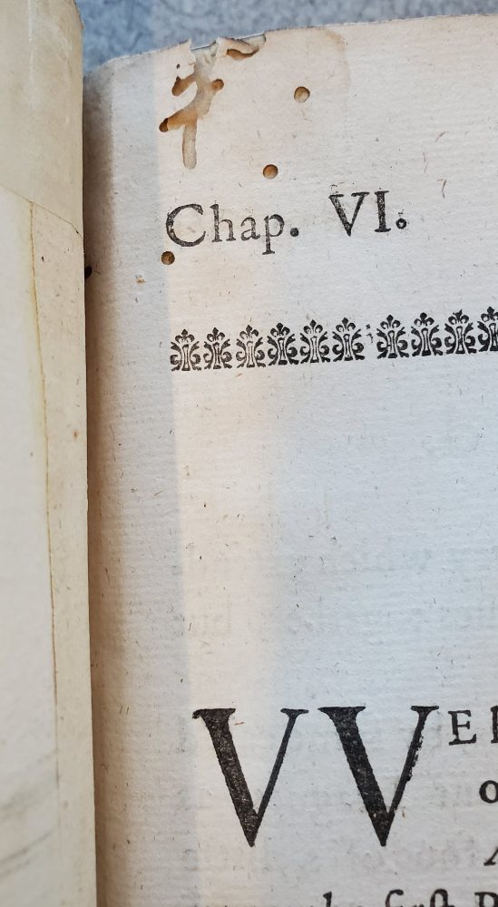 Bookworm holes at the edge of a page.