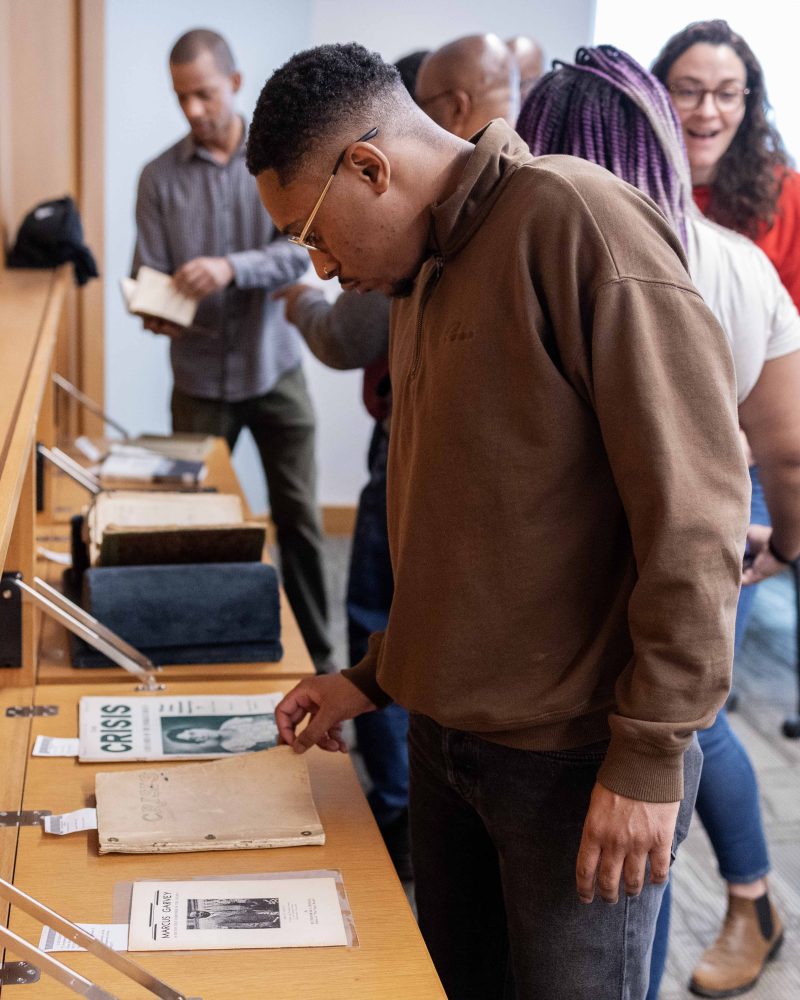 Quentin Francis, director of youth development at the Ann Arbor YMCA in Michigan, examines materials from the Givens Collection of African American Literature, on Wednesday, April 17, 2024. (Photo/Adria Carpenter)