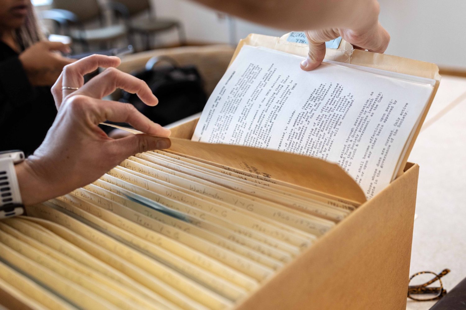 Lindsey Pullum, program director of YMCA Youth and Government, scans through folders from the Kautz Family YMCA Archives, on Wednesday, April 17, 2024. (Photo/Adria Carpenter)
