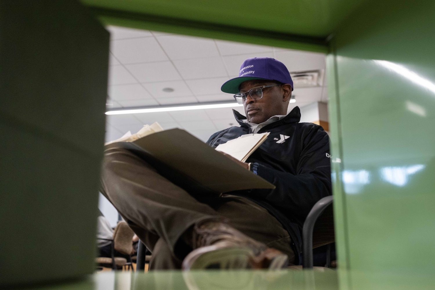 Michael DeVaul, national director of Boys and Young Men of Color, looks through materials from the Kautz Family YMCA Archives, on Wednesday, April 17, 2024. (Photo/Adria Carpenter)