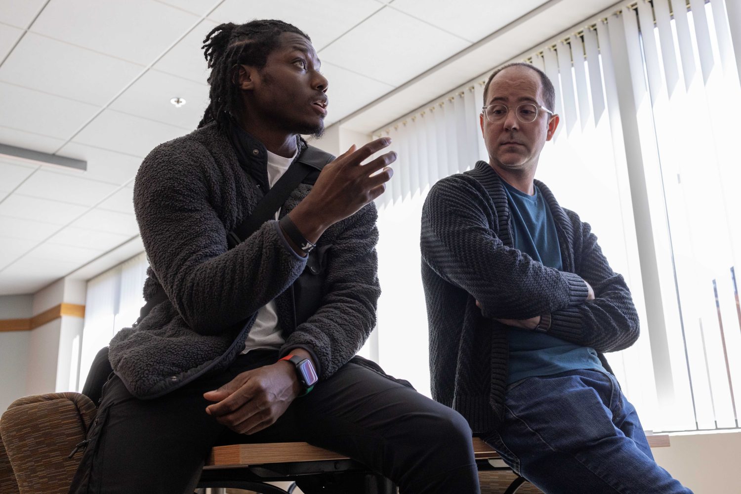 Devin Anglin, national coordinator for Boys and Young Men of Color, speaks with Ryan Bean, archivist for the Kautz Family YMCA Archives, on Thursday April 18, 2024. (Photo/Adria Carpenter)