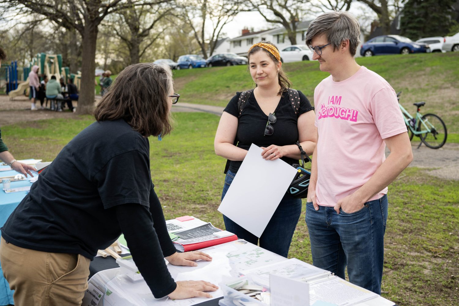 Jon and Becca Wonder learn about the racial covenant on her home with Rebecca Gillette, the Mapping Prejudice community engagement lead, at Sanborn Park in Robbinsdale, Minnesota, on Friday, May 3, 2024. (Photo/Adria Carpenter)