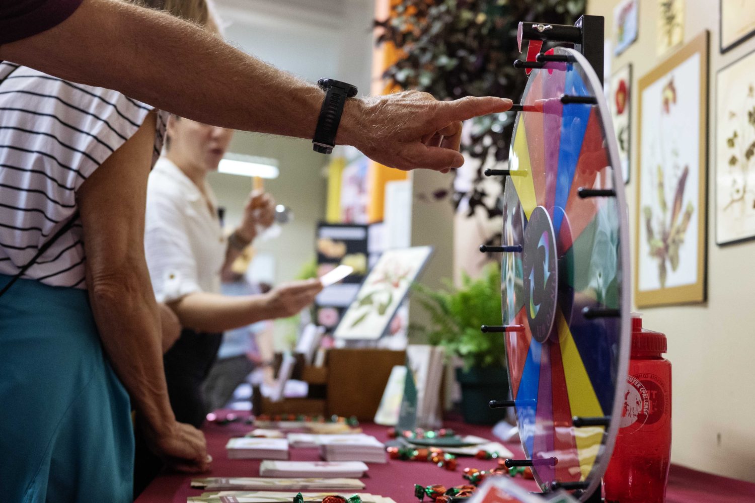 An attendee spins the wheel at the Andersen Horticultural Library's booth at the Minnesota State Fair on Thursday, August 29, 2024. (Photo/Adria Carpenter)