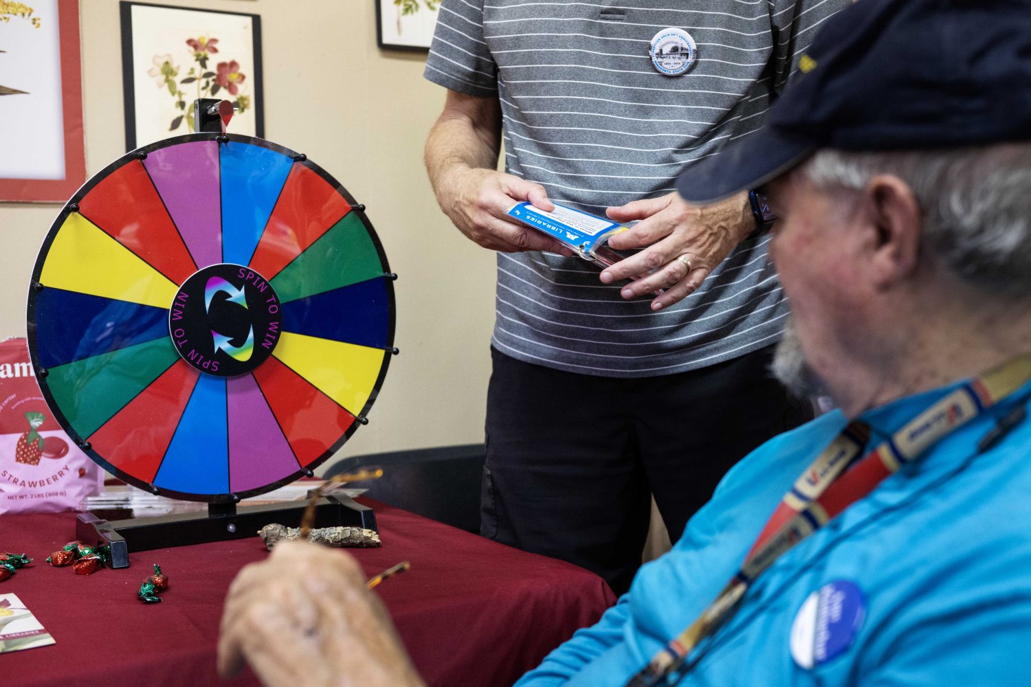 An attendee spins the wheel at the Andersen Horticultural Library's booth at the Minnesota State Fair on Thursday, August 29, 2024. (Photo/Adria Carpenter)