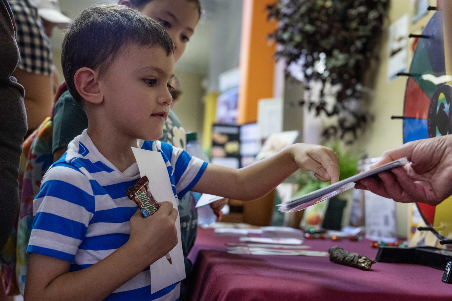 An attendees answers trivia questions at the Andersen Horticultural Library's booth at the Minnesota State Fair on Thursday, August 29, 2024. (Photo/Adria Carpenter)
