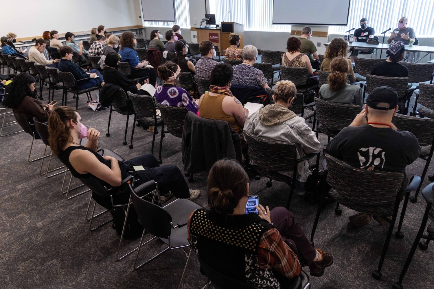 Milo Miller and Chris Wilde, co-founders of the Queer Zine Archives Project, speak at the Midwest Queer and Trans Zine Fest conference at Andersen Library in Minneapolis on Friday, October 18, 2024. (Photo/Adria Carpenter)
