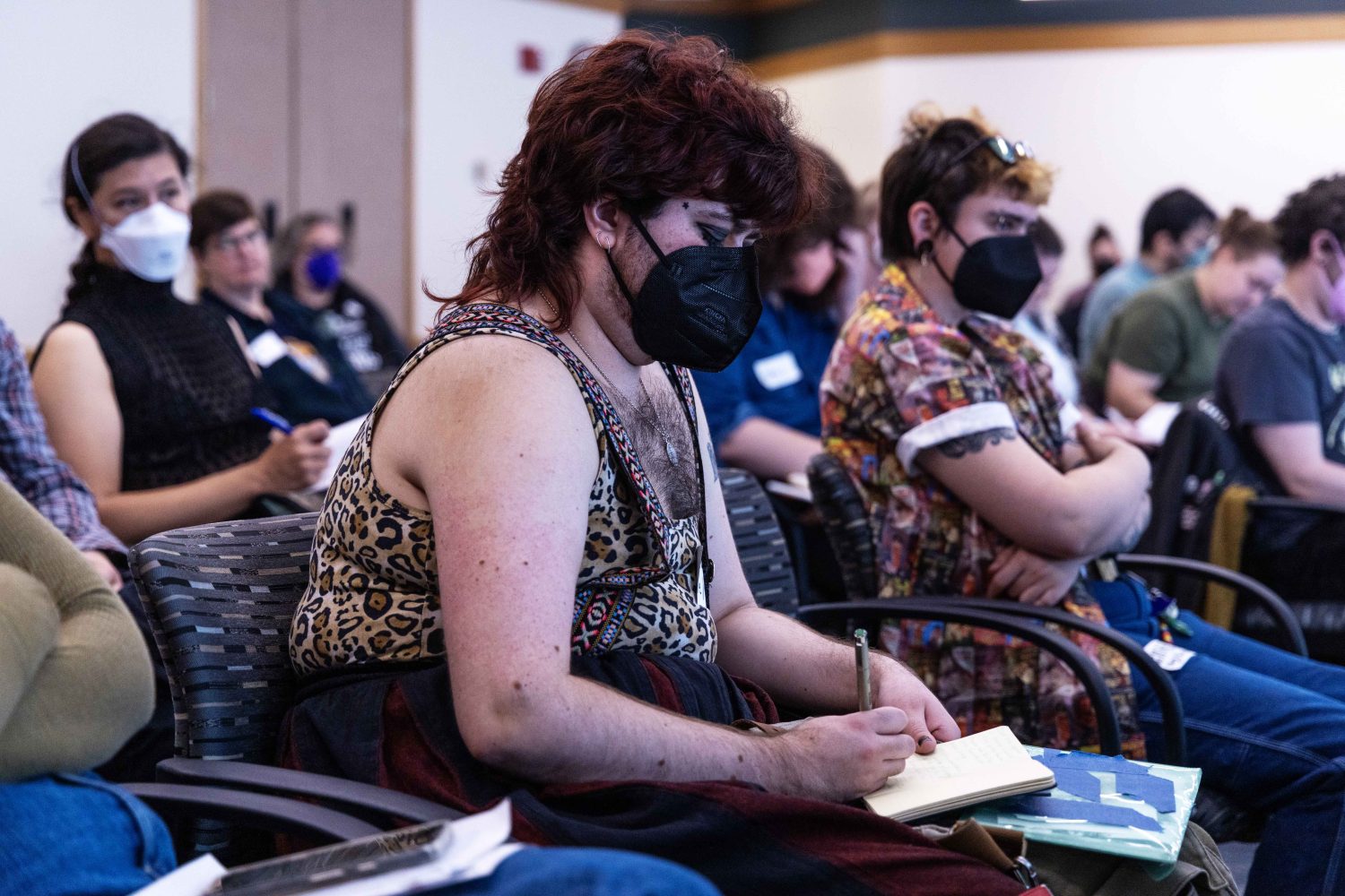 Attendees take notes during the Midwest Queer and Trans Zine Fest conference at Andersen Library in Minneapolis on Friday, October 18, 2024. (Photo/Adria Carpenter)