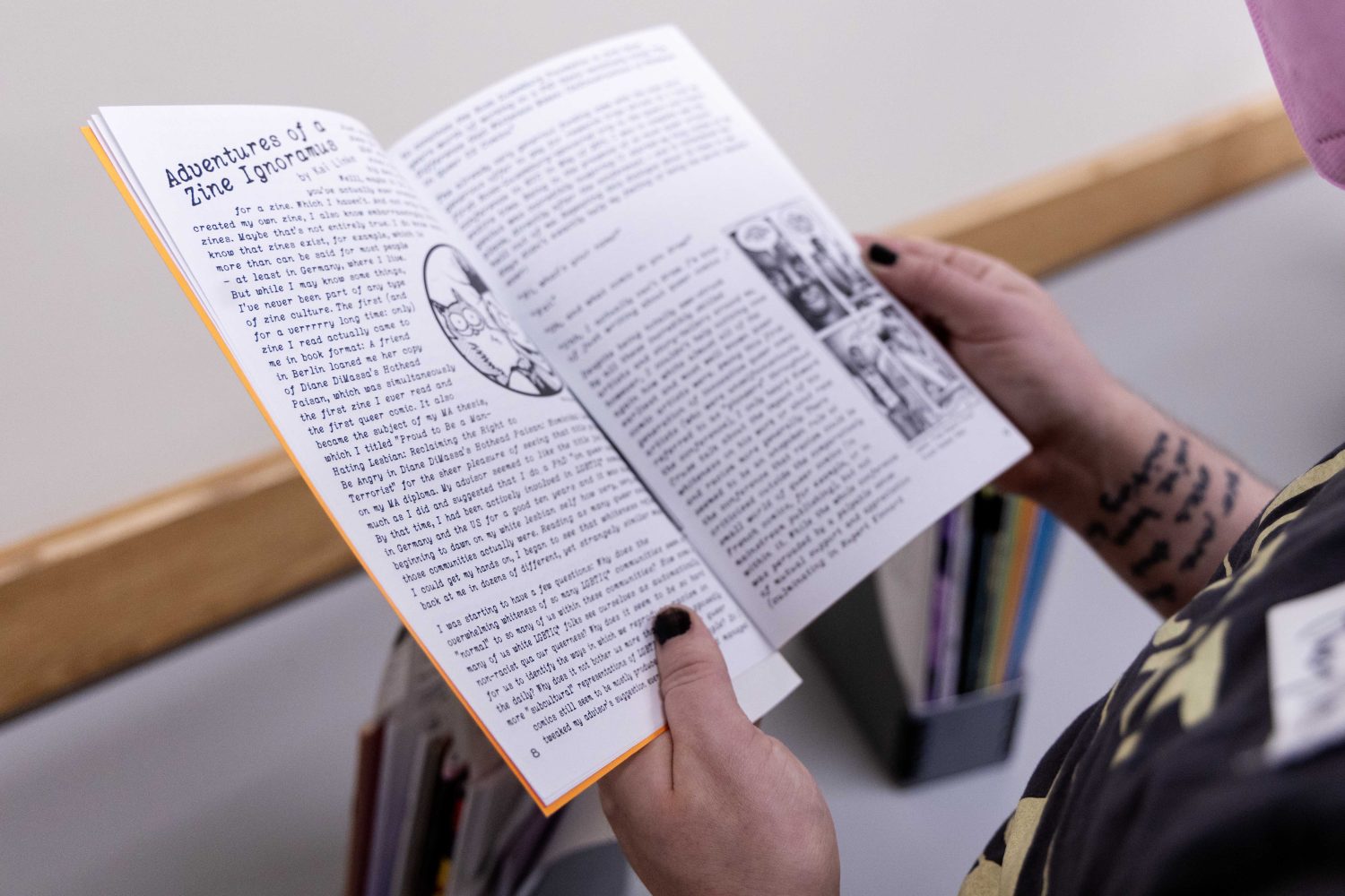 Attendees look at zines from the Tretter Collection during the Midwest Queer and Trans Zine Fest conference at Andersen Library in Minneapolis on Friday, October 18, 2024. (Photo/Adria Carpenter)