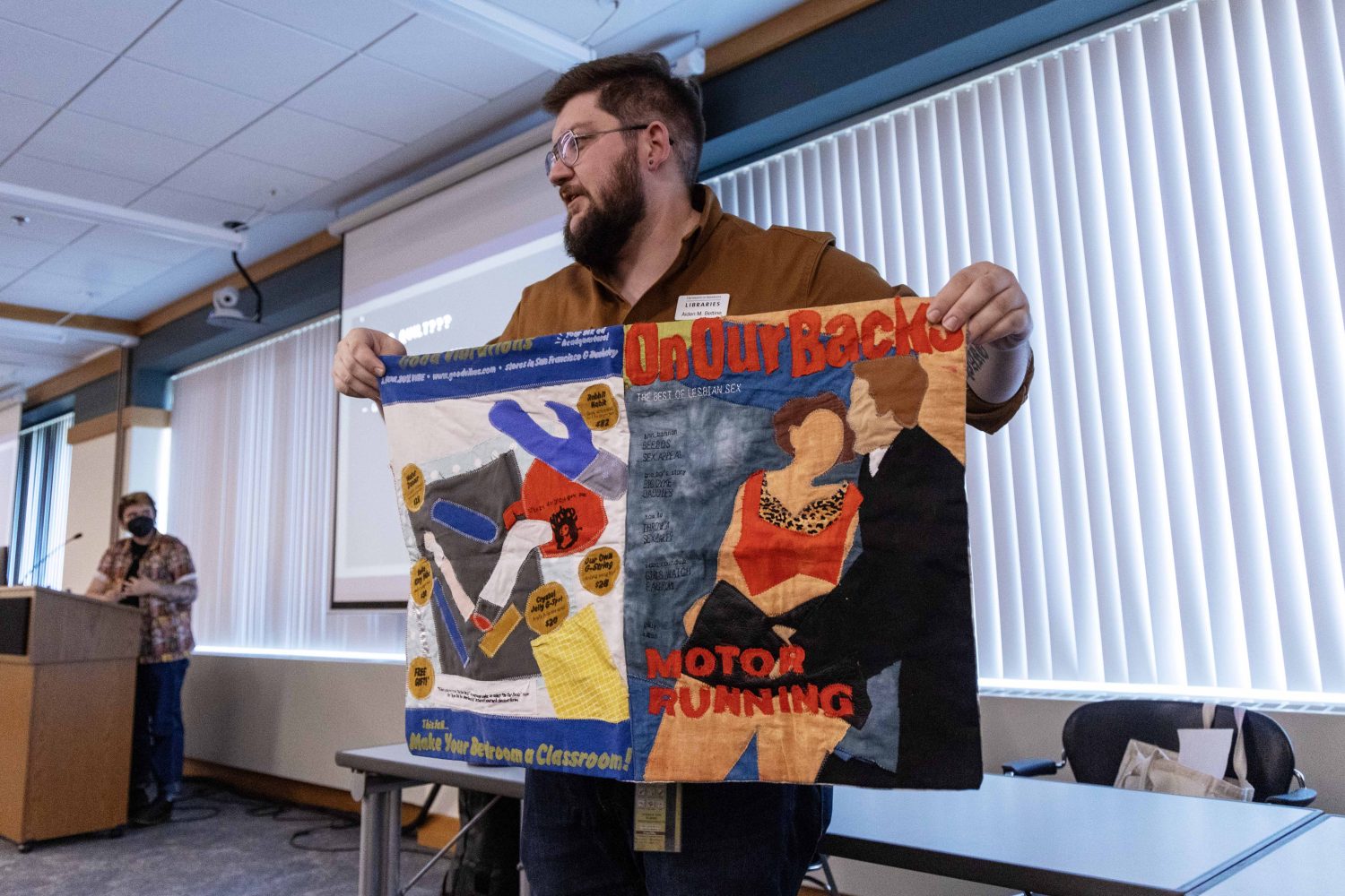 Aiden Bettine, curator of the Tretter Collection, holds textile art created by Cedar Meik on Friday, October 18, 2024. (Photo/Adria Carpenter)