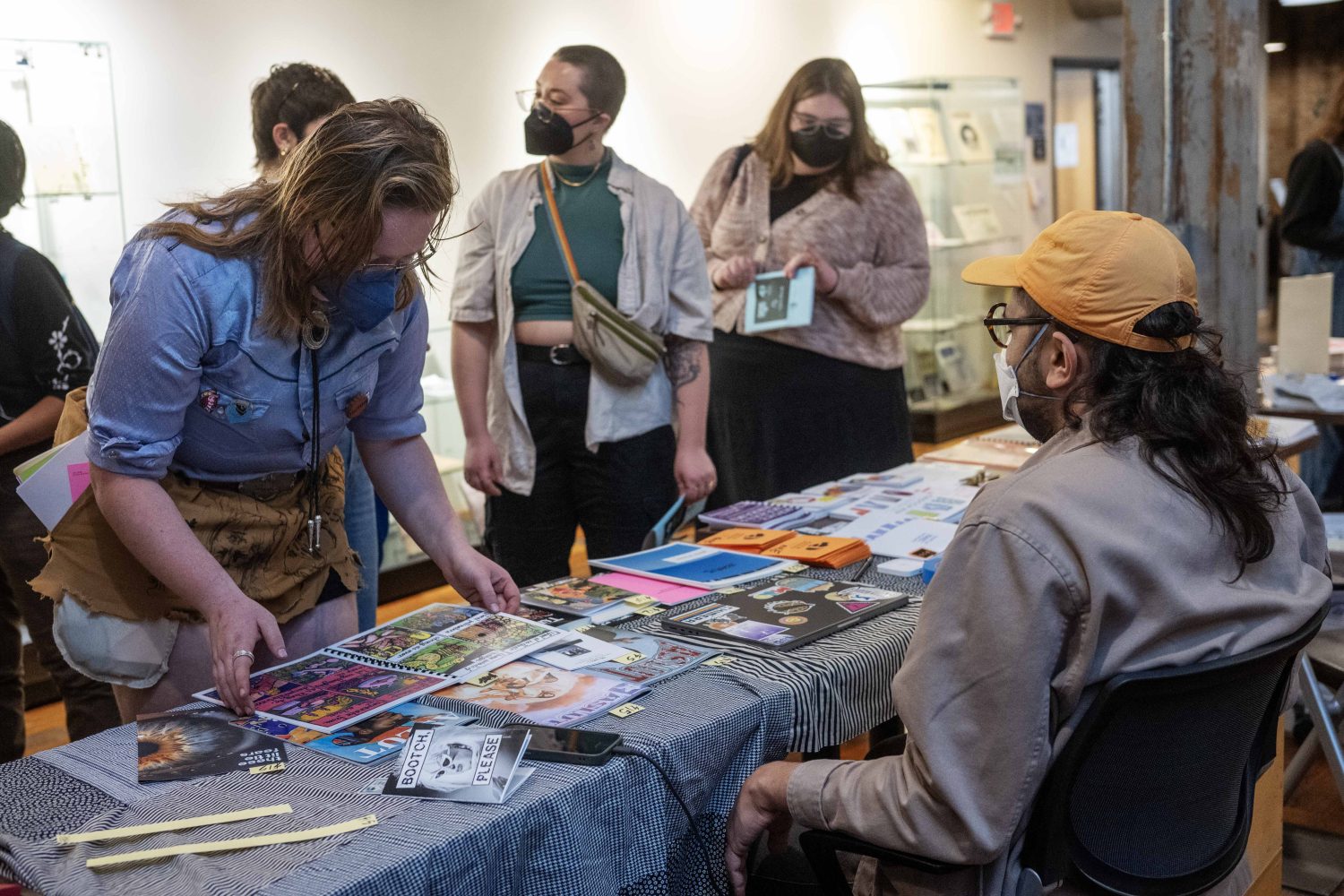 Zach Frazier, founder of Astringent Press and the Midwest Zine Archive, displays zines during the Midwest Queer and Trans Zine Fest, on Saturday, October 19, 2024. (Photo/Adria Carpenter)