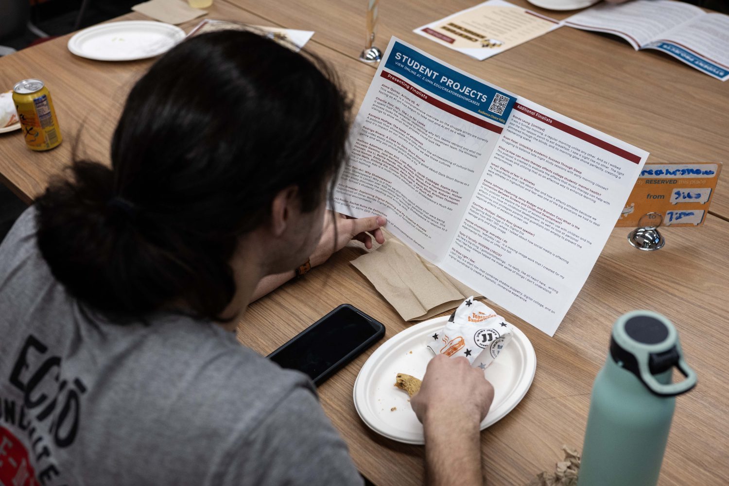 Jay Radke reads the Creators Showcase program on April 14, 2025. (Photo/Adria Carpenter)