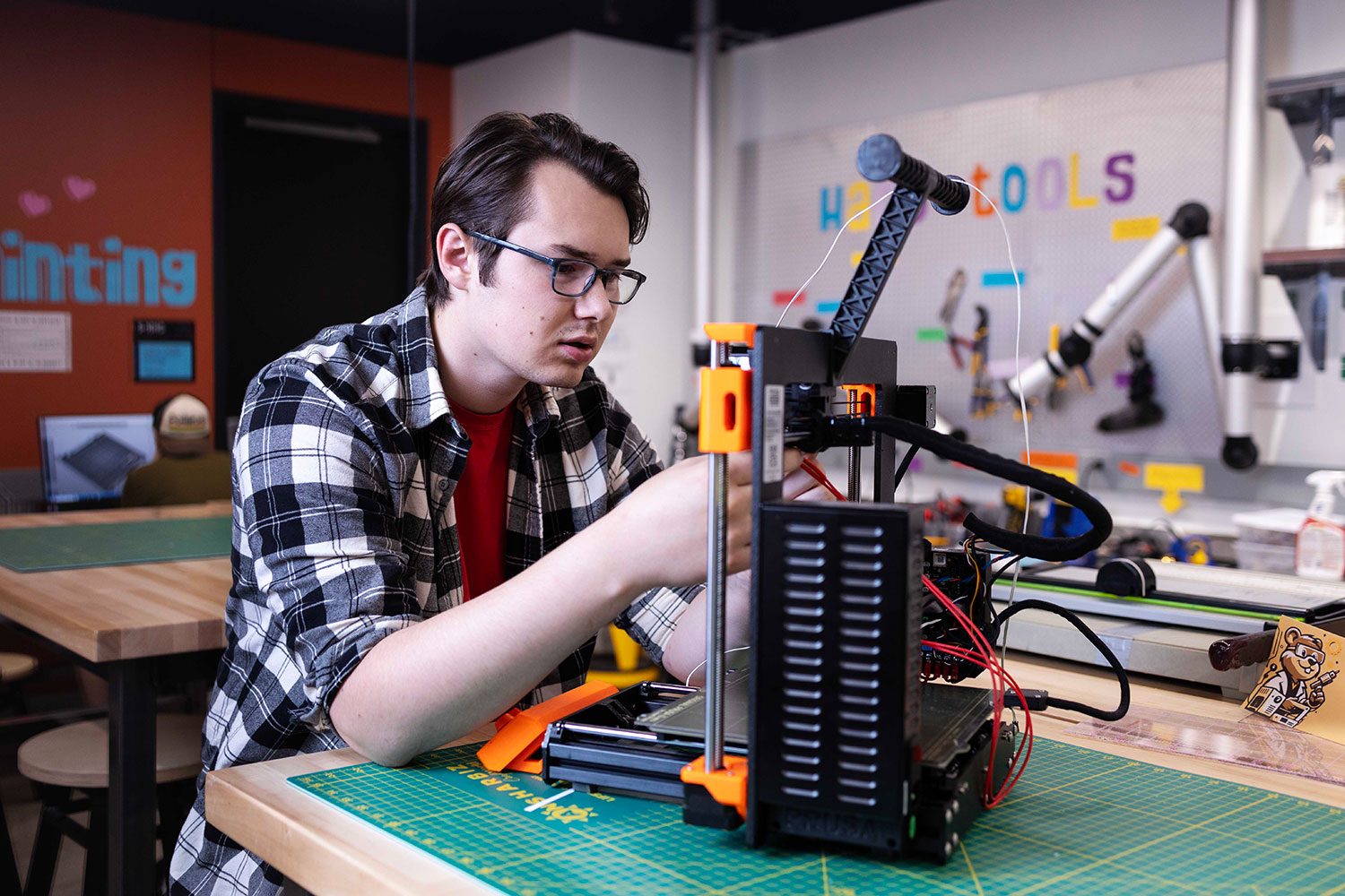 Student working on a 3D printer in the Makerspace in the Health Sciences Library