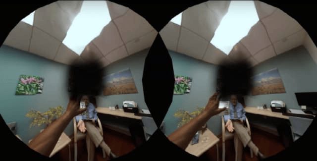 A video of a doctor's office viewed from inside a virtual reality headset. There is a black spot in the center of each eye indicating vision loss.